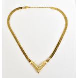 DIOR; a vintage Dior V-shaped gold toned and pave crystal necklace, length 40cm.
