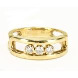 MESSIKA OF PARIS; an 18ct yellow gold 'Move Classic' ring, with three diamonds weighing 0.22cts,