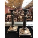 A pair of Swedish silver Corinthian column candlesticks, each raised on bun feet, impressed marks to