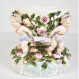 A large late 19th century Continental porcelain cherubic floral encrusted bowl, height 21.5cm,