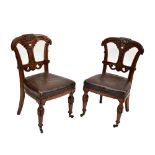 A pair of Victorian Gothic Revival walnut side chairs, on turned legs to castors (2).