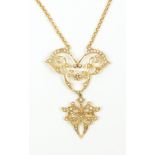 An Edwardian 15ct yellow gold open work floral motif pendant set with cultured fresh water seed