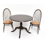 ERCOL; an elm circular dining table, on turned column to four outswept legs, approx 73 x 104cm,