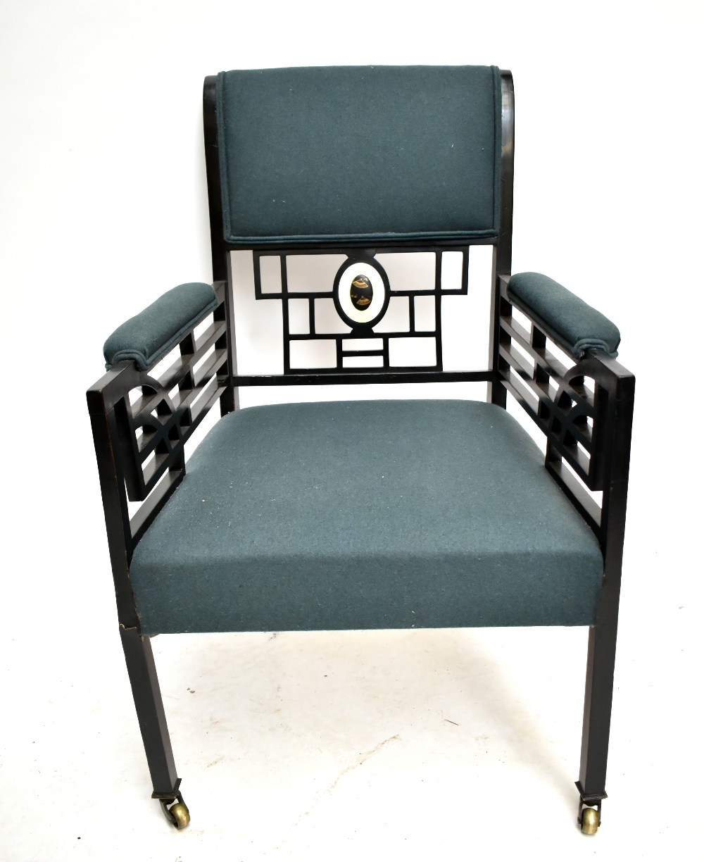 A late 19th century ebonised armchair, in the manner of Godwin, the back and side arms with - Image 2 of 2