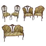 An Edwardian mahogany seven piece salon suite comprising settee, two tub chairs, and four side