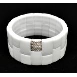 ROBERTO DEMEGLIO; a 'Domino' white ceramic and unmarked white gold diamond set expandable