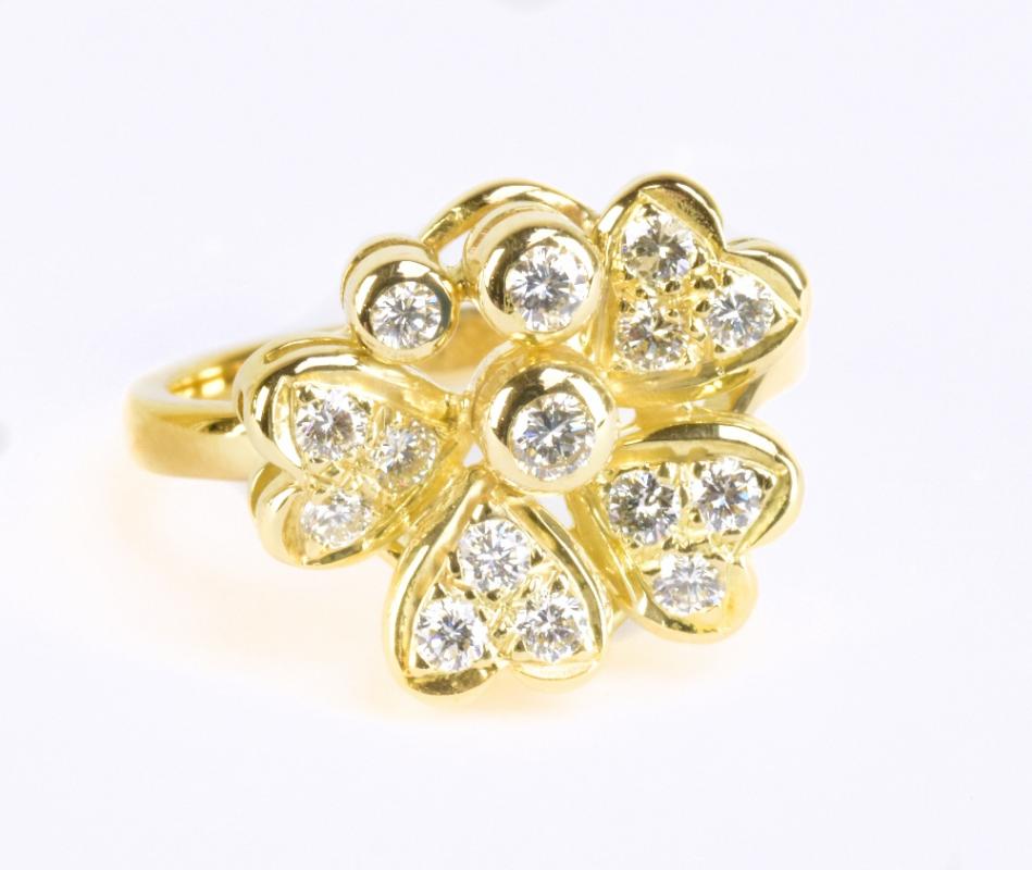 An 18ct yellow gold and diamond floral cluster stepped ring, size M 1/2, approx 6.5g.