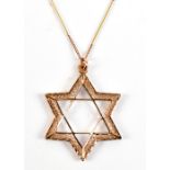 A yellow gold necklace with Star of David pendant and filigree detail, approx 8g.