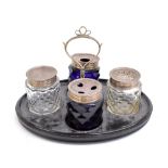 A George III ebonised cruet frame with a pair of Bristol Blue and a pair of clear glass silver