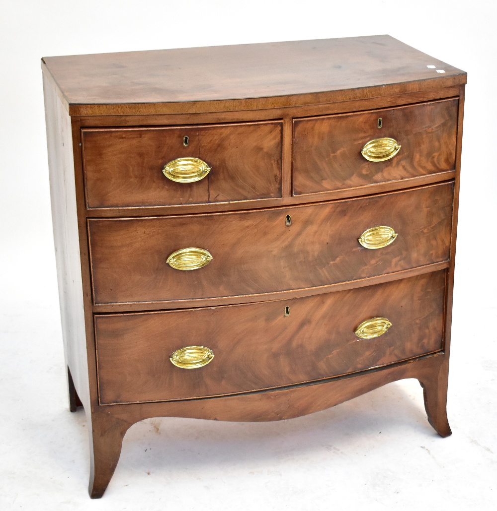 A Georgian mahogany bowfronted chest of two short over two long drawers, raised on bracket feet.