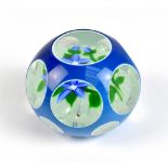 JOHN DEACONS; a double overlay glass paperweight, decorated with floral sprays and latticino