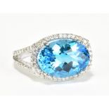 An 18ct white gold blue topaz and diamond ring, the large oval faceted topaz weighing approx 6cts,