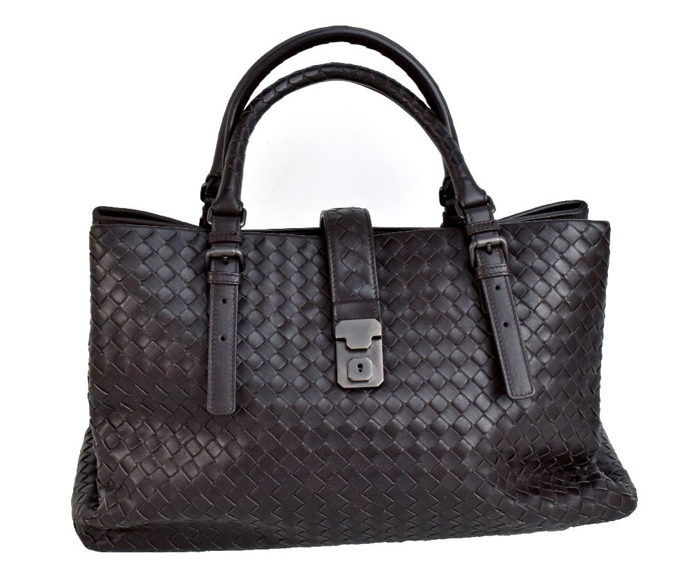 BOTTEGA VENETA; a ROMA dark brown braided calf skin handbag, with small front brass closure, and