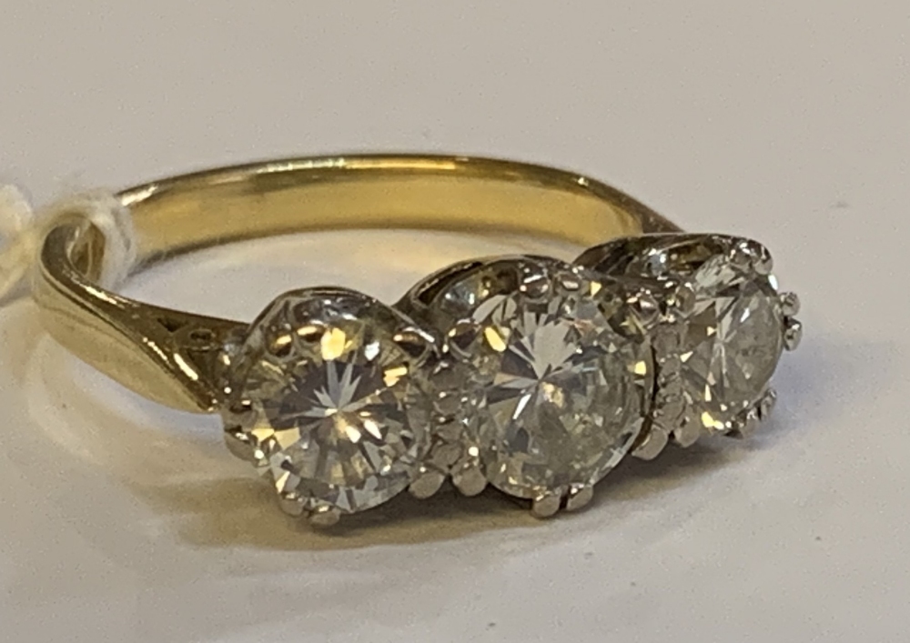 An 18ct yellow gold and diamond three stone ring, the central round brilliant cut stone weighing - Image 2 of 8