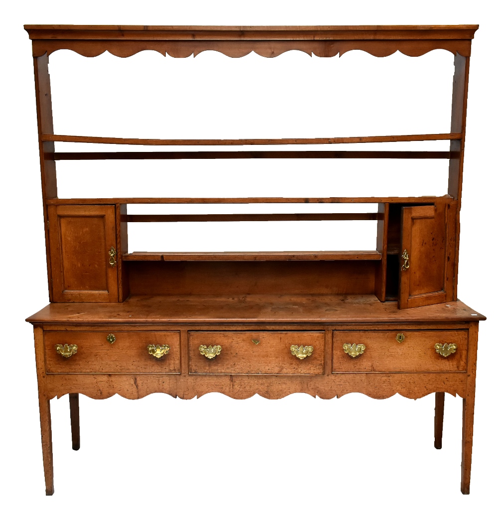 An 18th century oak dresser with plate rack back, the back with two thick shelves and two panelled