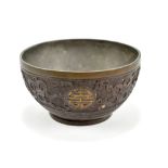 A Chinese tea bowl featuring shou characters within band of Buddhist emblems in relief, indistinct