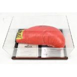 MUHAMMAD ALI; a signed Everlast boxing glove with Stacks of Plaques certificate, presented in