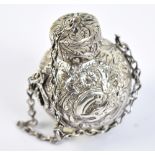 A circular 1900 white metal perfume/incense bottle with profusely engraved decoration featuring