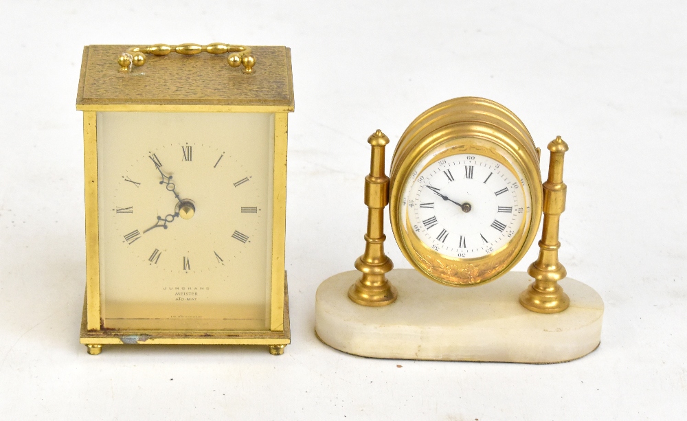 A gilt metal and alabaster time piece, the white enamel dial set with Roman numerals, height 11cm,