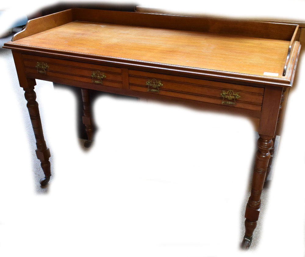 A late Victorian walnut two drawer side table raised on turned and block legs to castors, width