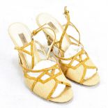 PRADA; a pair of cream canvas and leather strappy sandals with transparent plexi-glass heel