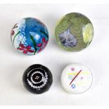 CAITHNESS; four glass paperweights comprising 'Noughts and Crosses', 'Orchids', 'Wind Flower Ruby'