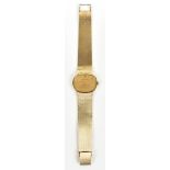 BUECHE-GIROD; a lady's vintage 9ct yellow gold wristwatch with oval dial and integral textured