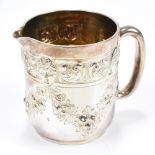 WAKELY & WHEELER; a Victorian hallmarked silver cream jug with repoussé mask and floral swag