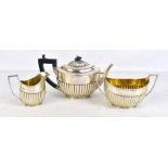 WALTER & JOHN BARNARD; a Victorian hallmarked silver three piece tea set with gadrooned detail,