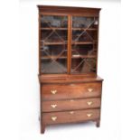 A 19th century mahogany bookcase with twin astragal glazed doors enclosing three shelves, on