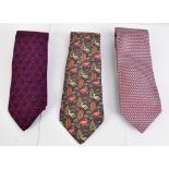 HERMÉS; a red and blue silk tie, a red and grey patterned silk tie and a green, grey and pink bird