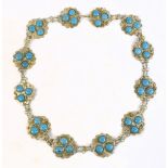 A white metal Middle Eastern sectional belt, set with blue cabochon stones, length 88cm.