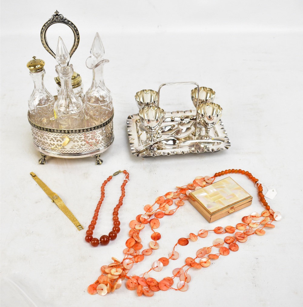 A silver plated condiment stand with pierced detail on four claw feet housing four clear glass