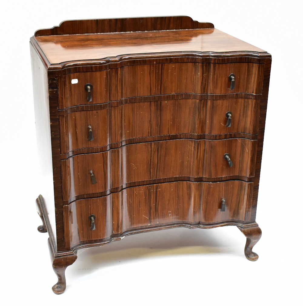 An Art Deco walnut four drawer chest of shaped outline on cabriole legs.