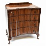 An Art Deco walnut four drawer chest of shaped outline on cabriole legs.