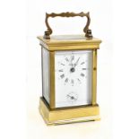 ANGELUS; a French brass carriage clock, the circular enamel dial set with Arabic and Roman