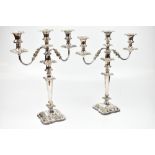 A large pair of silver plated three branch candelabra on spreading shaped bases, height 46cm (2).