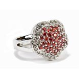 A white metal diamond and red sapphire cluster ring, the round sapphires approx total 1.1ct and