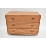 ERCOL; a light elm three drawer chest of drawers, width 91cm.