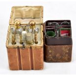 An early 20th century leather-bound sewing kit, together with a similar example in the form of a