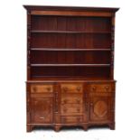 A Victorian mahogany breakfront dresser, with plate rack back above four central drawers flanked