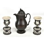 WEDGWOOD; a pair of black and white jasper dip urns on stands, height 17.5cm and an unmarked black