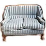 An early 20th century blue striped upholstered sofa on carved front cabriole legs, length 120cm.