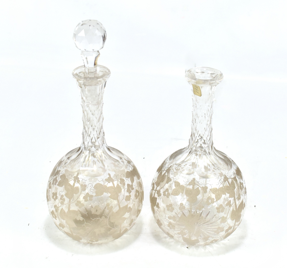 A pair of 19th century glass decanters with good quality engraved detail of vines and leaves to