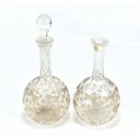A pair of 19th century glass decanters with good quality engraved detail of vines and leaves to