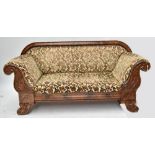 A 19th century carved mahogany framed chaise longue, the arms and legs with detailed carving