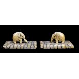 A pair of model elephants carved from mammoth tooth on rectangular bases, approx 4.9 x 5cm.