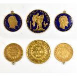 Three French 19th century gold and enamelled coins, comprising 1876 20 francs and two 5 francs for