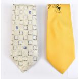 VERSACE; a gold and black silk tie with Versace logo and a cream and blue patterned tie (2).
