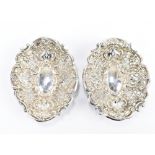 GEORGE UNITE; a pair of Victorian hallmarked silver pierced foliate motif bonbon dishes, each on